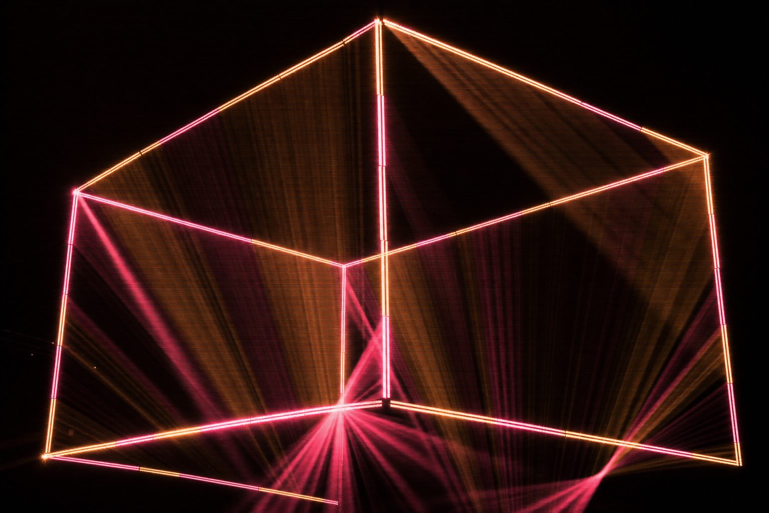 The edges of a large cube drawn in light and seen from a low corner, so that near and far edges cross, the mapped seams along each edge slightly misaligned where the surface turns.