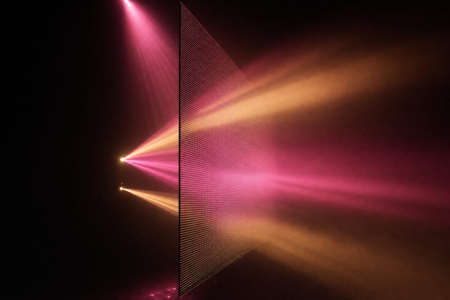 One large translucent plane seen almost edge-on, its lattice of fine diodes just resolvable, haze passing through it so the plane reads as an object with a front and a back.