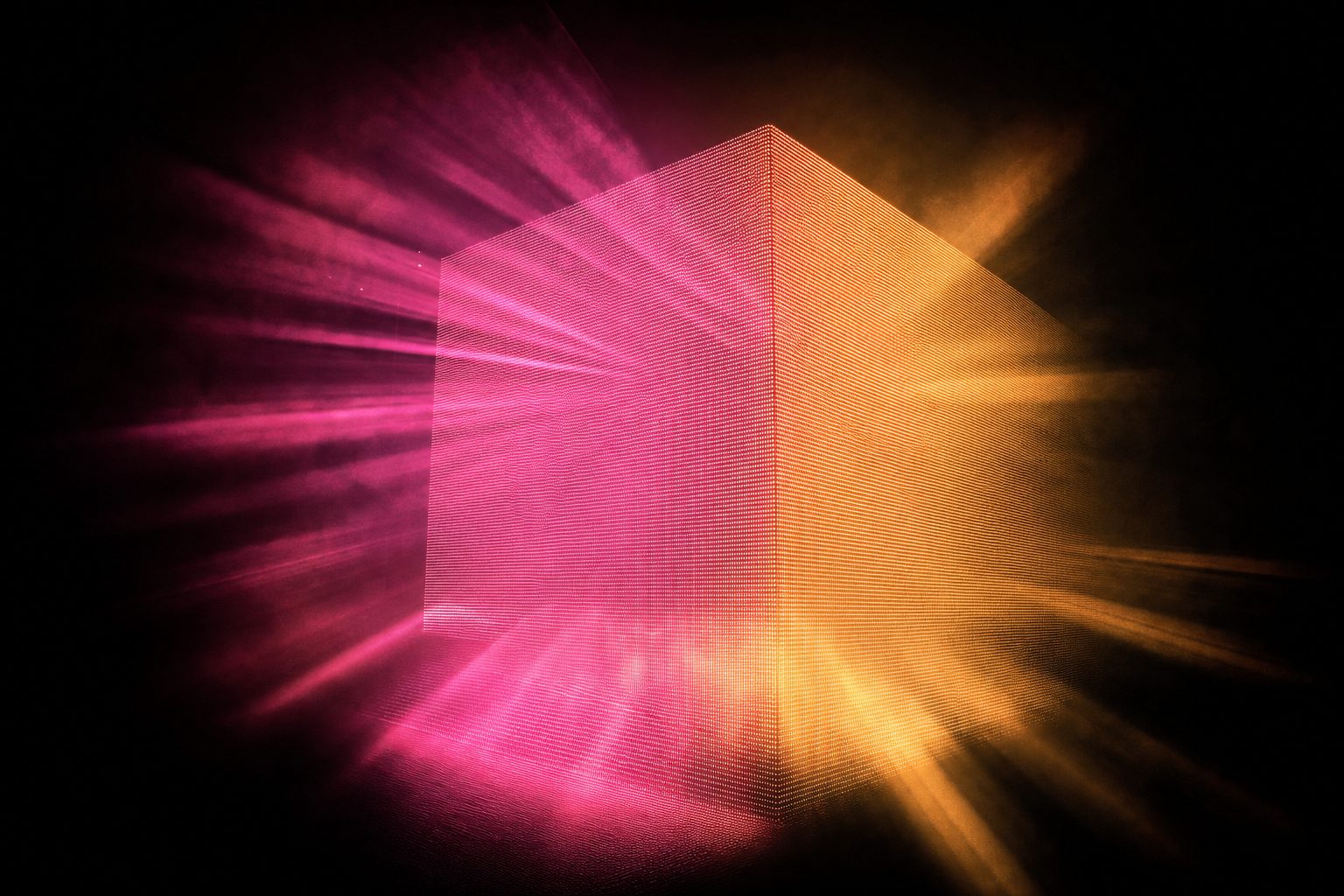 A deep block of light built from many closely stacked lines of diodes, dense enough that the interior of the block reads as solid volume rather than as a surface.