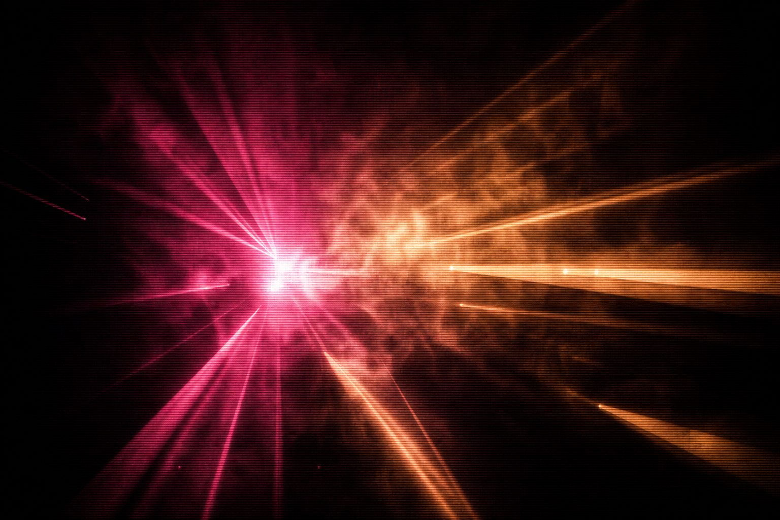 A decaying burst of magenta and amber light, residual glow lingering in thick haze.