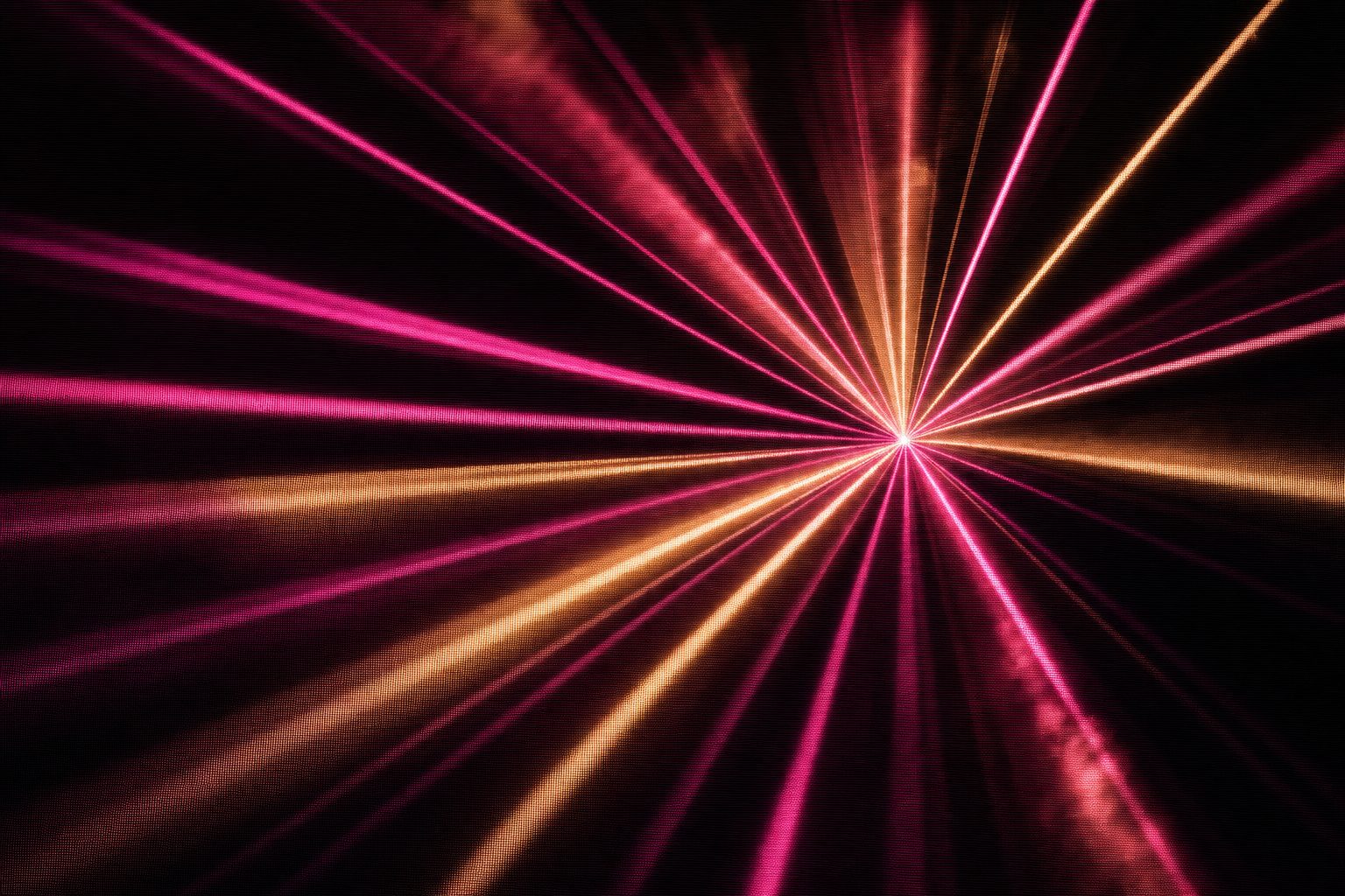 A burst of radiating magenta and amber beams from a single point, chaotic and celebratory.